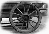 Image of a wooden wheel from a vintage manual pumper in South America